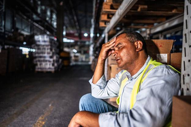 A person in a warehouse holding his head

AI-generated content may be incorrect.